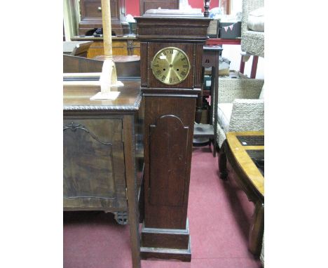 An Oak Grandmother Clock, with a caddy top, brass dial, shaped door, on a plinth base.