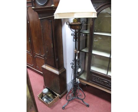 A XX Century Cast Iron Standard Lamp, with a brass and copper well, telescopic action, with applied 'S' scroll decoration, on