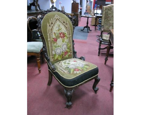 A XIX Century Walnut Chair, with a carved top rail and side with 'C' scroll decoration, with a tapestry back and seat on cabr