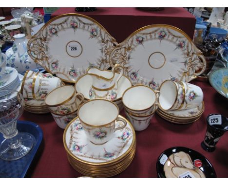 A Late XIX Century Tea Service, decorated with floral swags and gilt highlighted, comprising two sandwich plates, sugar bowl,