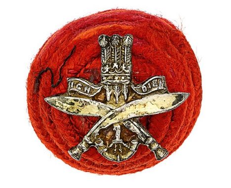 1st Gurkha Rifles Officer’s red cord boss bearing silvered badge.Boss mounted with Prince of Wales’s plumes on crossed kukris