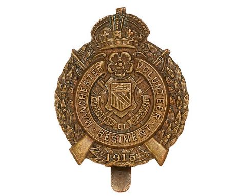 Manchester Volunteer Regiment WW1 VTC cap badgeGood die-stamped bronze crown over rose and title scroll with central city Arm