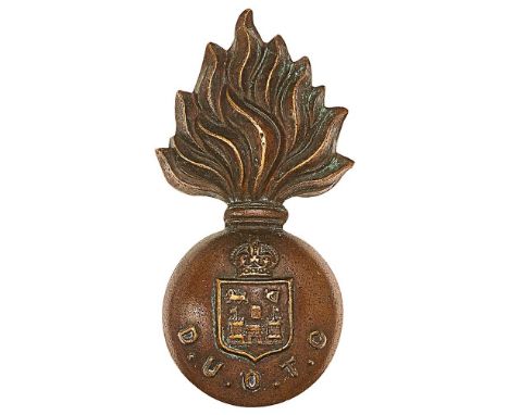 Irish Dublin University OTC field service cap badge circa 1902-22.Die-stamped bronze flaming grenade bearing crowned Universi