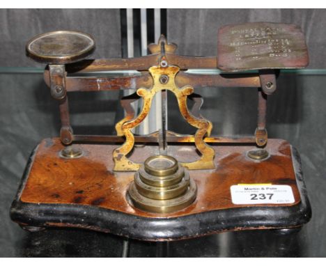 A set of post office scales with four brass weights, 18cm