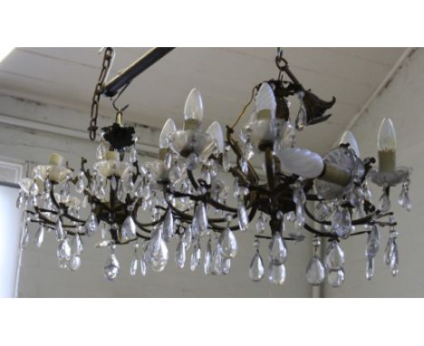 A pair of gilt metal eight light electroliers with cut glass pendants and drip pans, 48cm diameter 