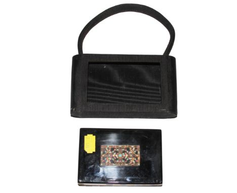 A ladies black enamel vanity case
