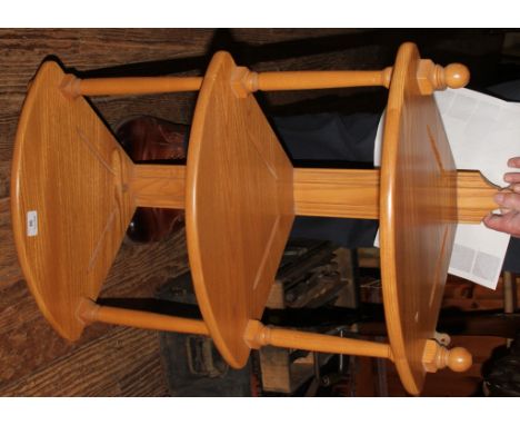 An Ercol oak three tier open corner shelf, with turned supports, 79cm high