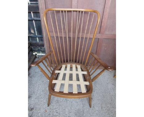 An Ercol dark elm lounge chair 