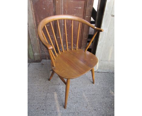 An Ercol smokers chair with cow horn back rail 