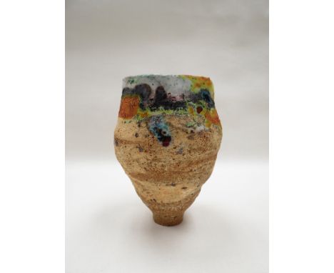 ROBIN WELCH (b. 1936) A Studio pottery rough textured vase with high fired coloured glazes around the rim. Impressed stamp. 1