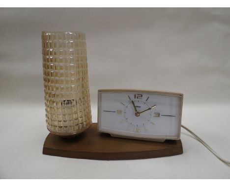 A Metamec electric alarm clock and lamp on a teak base 