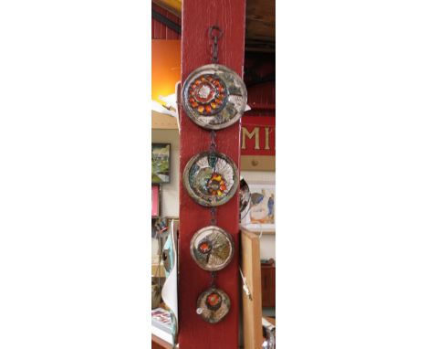 A wall hanging West German set of four textured circular ceramic tiles 