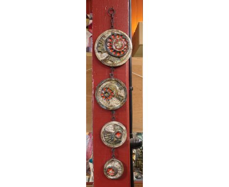 A wall hanging West German set of four textured circular ceramic tiles 