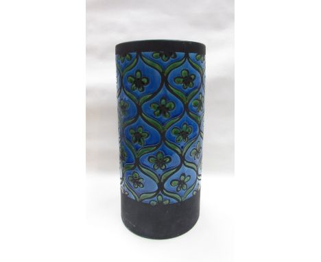 A large ceramic umbrella stand with blue and green glazed floral motifs. 42cm high 