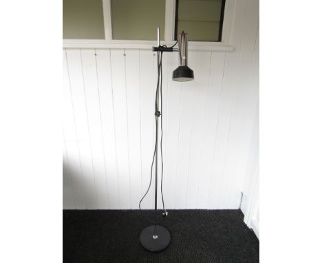 A floor standing chromed metal, adjustable spot lamp 