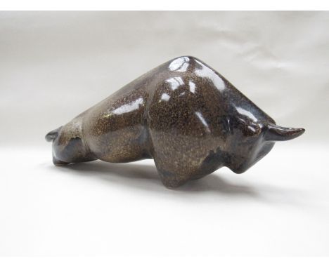 A ceramic stylised bull with a mottled purple/brown glaze, in the David Sharp, Rye, style, 15.5cm high x 35cm long