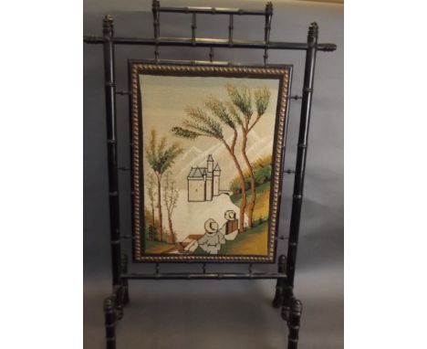 A faux bamboo fire screen with a tapestry panel depicting two people looking at a castle, 39'' high