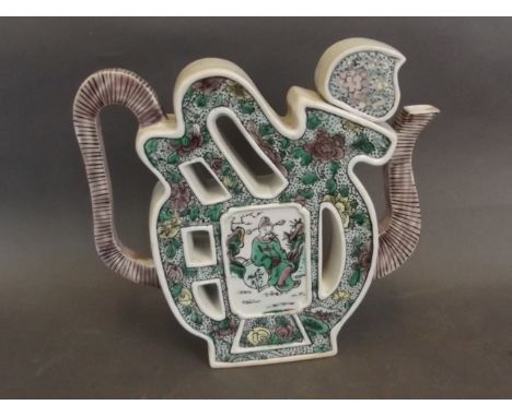 A Chinese puzzle teapot painted with flowers and a figure, 8'' high