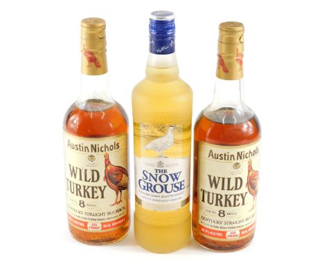 Two bottles of Austin Nichols Wild Turkey old number eight brand Kentucky straight bourbon, and a bottle of The Snow Grouse b