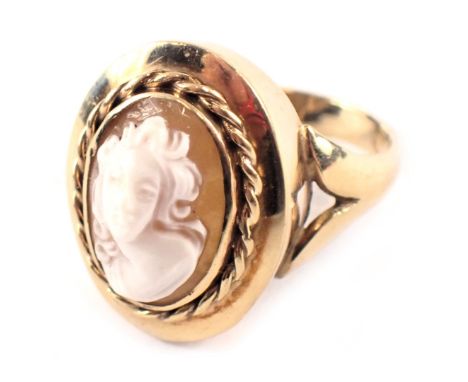 A 9ct gold cameo dress ring, the oval cameo depicting figure, in a rope twist rub over border with V splayed shoulders, ring 