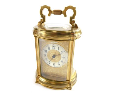 A late 19th/early 20thC French carriage clock, the white enamel dial with Arabic numerals within scroll cast surround, in an 