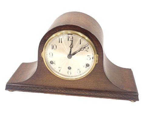 An oak cased Napoleon's hat mantel clock, with a silvered numeric dial and brass chapter ring, in a carved case, 21cm high, 3