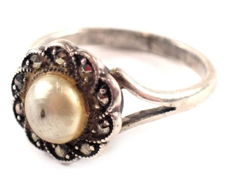 A silver dress ring, formed as a marcasite floral cluster, with central cultured pearl with V splayed shoulders, unmarked, ri