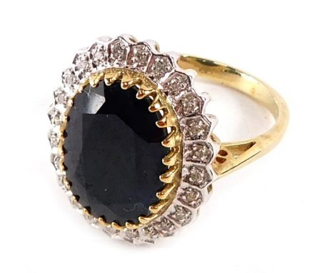 A 9ct gold cluster ring, the central oval black stone in rub over setting, surrounded by tiny diamonds to pave setting, in wh