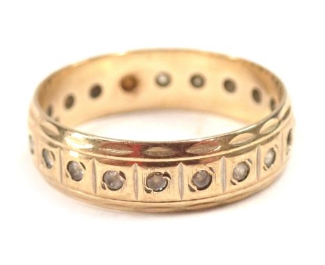 A 9ct gold eternity ring, set with white stones, with petalated border, ring size R½, 2.9g all in. 