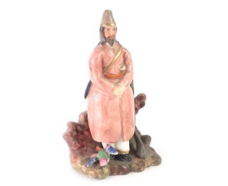 A Russian porcelain figure, of a gentleman in pink overcoat, with rifle, stamped FS, 16cm high. (AF)