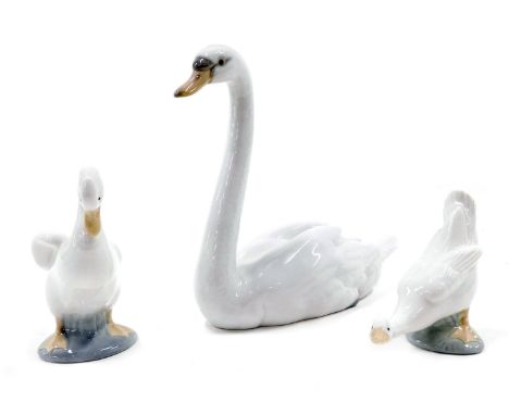 A Lladro seated swan and two Nao ducks. 