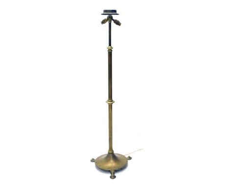An early 20thC adjustable brass standard lamp, in Art Nouveau style, with a hammered circular base, 132cm high. WARNING! This