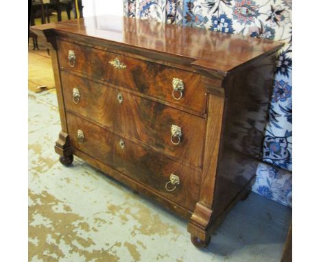 COMMODE, French mid 19th century mahogany with three long drawers below having lion mask handles on bun feet, 102cm W x 79cm 