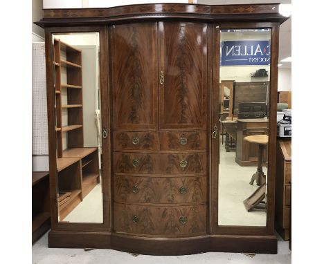 An Edwardian mahogany and satinwood banded breakfront wardrobe compactum, the moulded dentil cornice over a lozenge panelled 