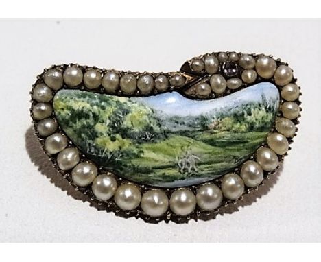 Yellow metal brooch set with seed pearls and an amethyst designed as a coiled serpent around an enamel landscape painted plaq