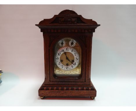Junghans oak case three train bracket clock with strike/silent Westminster chime. The brass engraved dial with silvered chapt