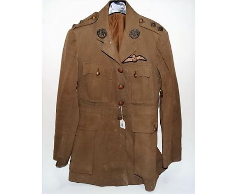 A British Officer's green tunic, applied with two Cornwall Light Infantry badges to the lapels, Cornwall Light Infantry brass