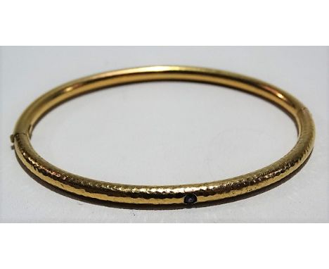Contemporary 14ct gold sapphire set bangle with planished finish, stamped 585, weight 11g approx.
