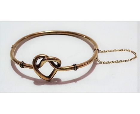 Early 20th Century 15ct gold hinged hollow bangle with heart shaped knot, stamped 15ct, weight 7.9g approx