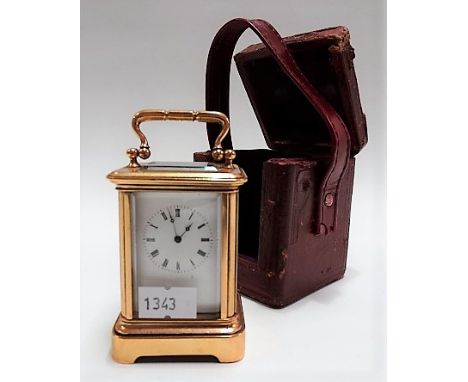 Miniature brass carriage timepiece, the 1.25in white enamel dial with Roman Numerals, within a corniche case, the movement st