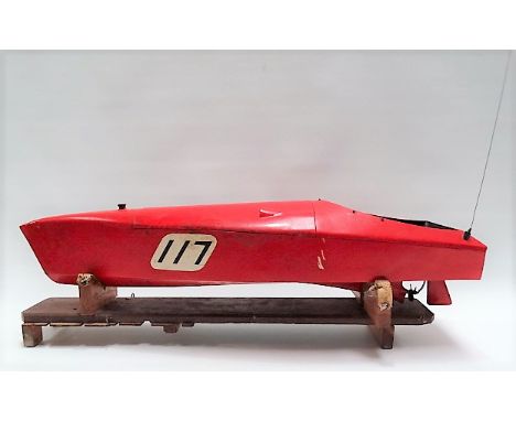 Vintage pond speedboat with engine, red painted upon stand, length 85cm