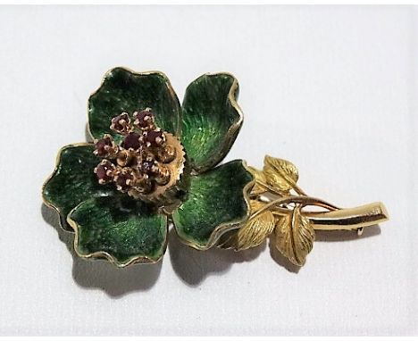 High purity gold green enamel and ruby set articulated flower brooch, the leaves open and close to reveal a centre with eight