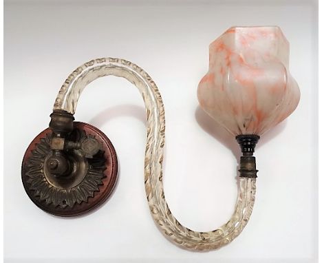 A wall mounting brass light fitting with glass arm and opaque marbled glass shade