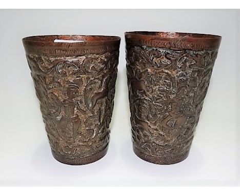 Pair of Indian brass under enamel embossed cylindrical tapered vases decorated with figures and animals within leaf scrolls, 
