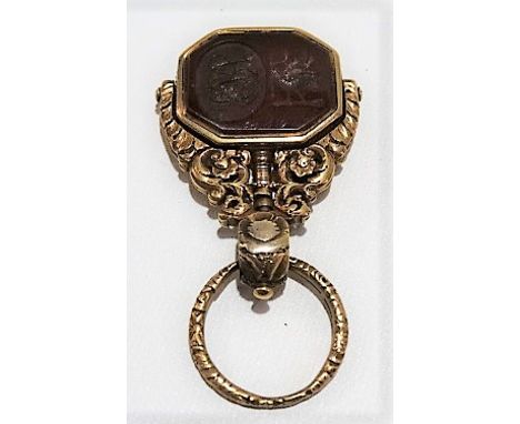 Good early 19th Century high purity gold swivel fob, with foliate embossed suspension ring and foliate scroll cast and pierce