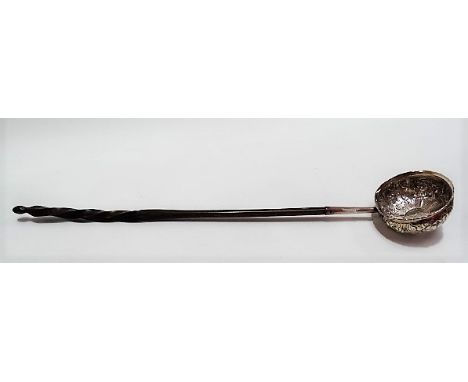 Georgian silver punch ladle with foliate embossed bowl inset with a George II sixpence, with baleen handle, length 36cm.