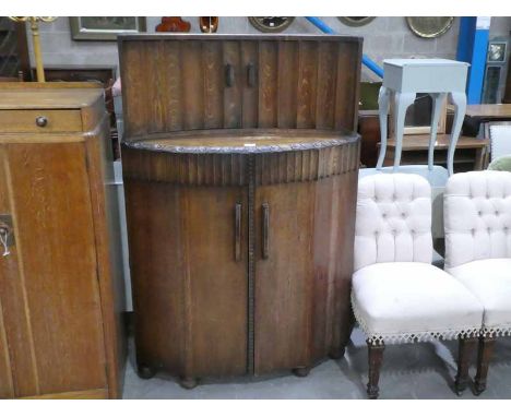 An Art Deco Ercol oak two tier Cocktail Cabinet with fluted doors to Spirit Cabinet 147cm high X 97cm wide 