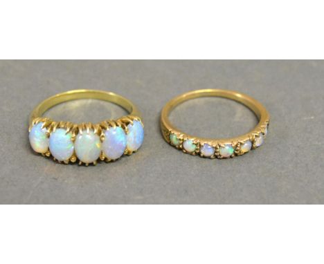 A Yellow Gold Opal Set Ring set with five opals together with another similar 9ct. gold and opal set ring 