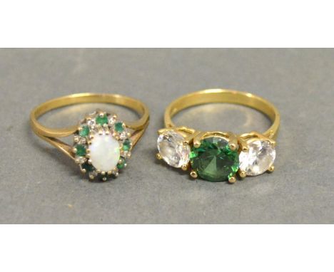 A 9ct. Yellow Gold Opal, Emerald and Diamond Cluster Ring set with central oval opal surrounded by emeralds and diamonds with