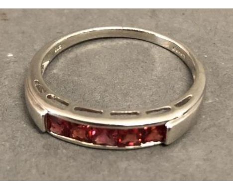 A 9ct. White Gold Band Ring set five Garnets 